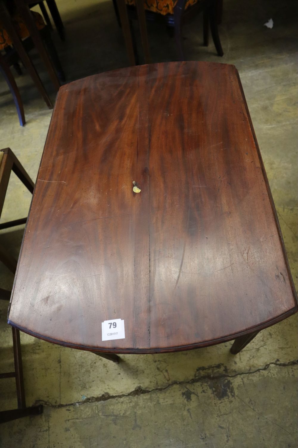 A George III mahogany Pembroke table, with oval top and moulded squared legs, width 77cm